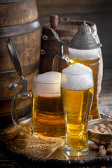 Light beer in a glass on a table in composition with accessories on an old background