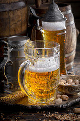 Light beer in a glass on a table in composition with accessories on an old background