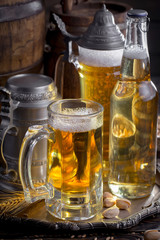Light beer in a glass on a table in composition with accessories on an old background