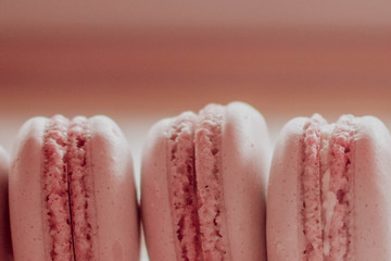 Strawberry french macarons closeup. Fresh and colourful on pink background
