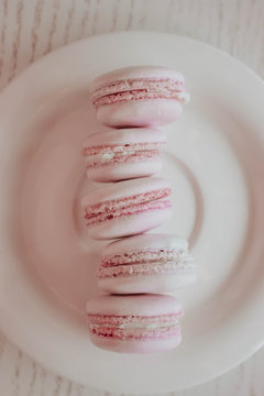 Strawberry french macarons closeup. Fresh and colourful on pink background