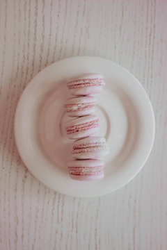 Strawberry french macarons closeup. Fresh and colourful on pink background