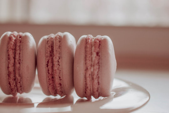 Strawberry french macarons closeup. Fresh and colourful on pink background