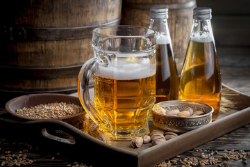 Light beer in a glass on a table in composition with accessories on an old background