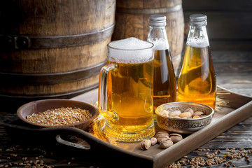 Light beer in a glass on a table in composition with accessories on an old background