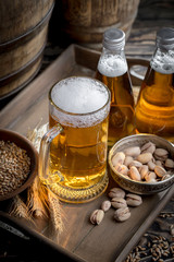 Light beer in a glass on a table in composition with accessories on an old background