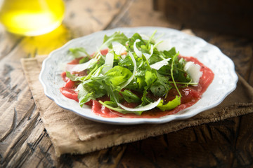 Beef carpaccio with arugula and Parmesan cheese