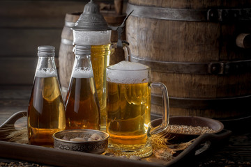 Light beer in a glass, on an old background.