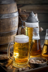 Light beer in a glass on a table in composition with accessories on an old background