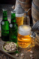 Light frothing beer in a glass, on an old background.