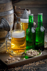 Light beer in a glass on a table in composition with accessories on an old background