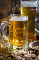 Light frothing beer in a glass, on an old background.