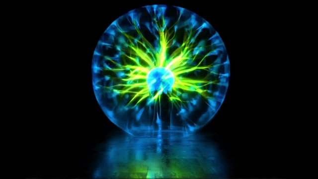 Plasma ball discharge lamp with high voltage lightning. Experiments with an electric Tesla coil and an inert gas discharge tube. Numerous outbreaks and lightning strikes. Abstract background. Looped