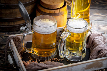 Light beer in a glass on a table in composition with accessories on an old background