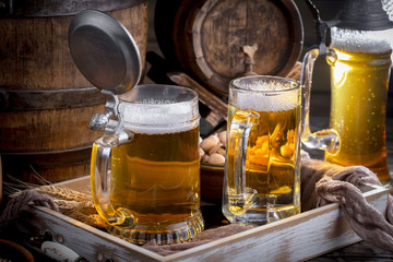 Light beer in a glass, on an old background.