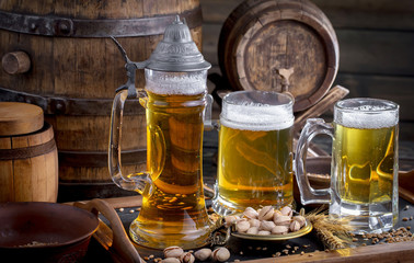 Light beer in a glass on a table in composition with accessories on an old background