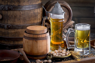 Light beer in a glass on a table in composition with accessories on an old background