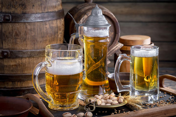 Light frothing beer in a glass, on an old background.