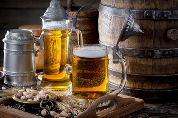 Light beer in a glass on a table in composition with accessories on an old background