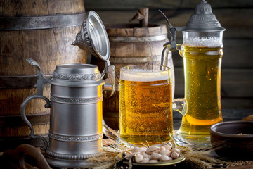 Light beer in a glass on a table in composition with accessories on an old background