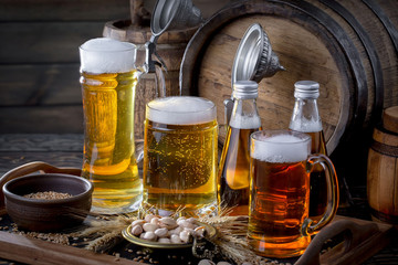 Light frothing beer in a glass, on an old background.