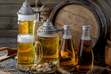 Light beer in a glass on a table in composition with accessories on an old background
