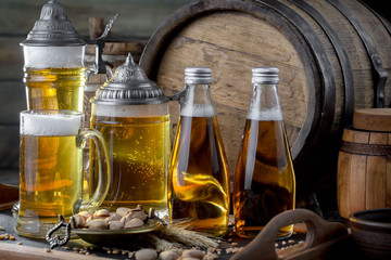 Light beer in a glass on a table in composition with accessories on an old background