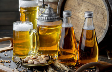 Light beer in a glass on a table in composition with accessories on an old background