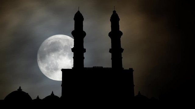 Jami Masjid: Time Lapse by Night with Big Full Moon and silhouette of or Jama Mosque, UNESCO World Heritage Site in Gujarat, India