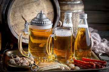 Light frothing beer in a glass, on an old background.