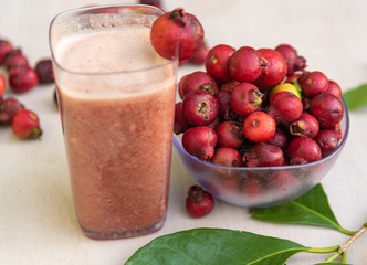Glass of juice and fruits of red aracá (Psidium cattleyanum Sabine) in natura