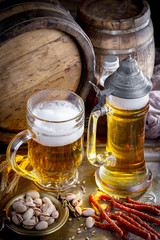 Light frothing beer in a glass, on an old background.