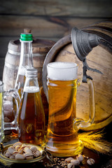 Light beer in a glass on a table in composition with accessories on an old background