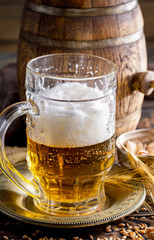 Light beer in a glass on a table in composition with accessories on an old background