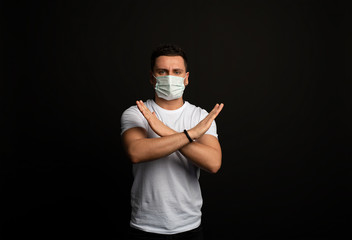 American man shows two arms crossed, showing no sign, a stop sign, emotions from the virus, colds,...