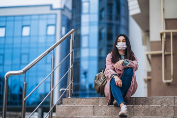 Female in medical protective mask outdoors in the empty city. Health protection and prevention of virus outbreak, coronavirus, COVID-19, epidemic and pandemic, quarantine concept