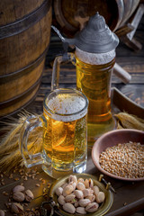 Light frothing beer in a glass, on an old background.