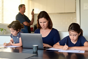 Family at home as the pandemic coronavirus (COVID-19) forces many employees and students to work...