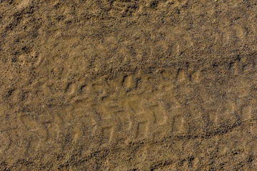 Tracks of the tires on a sand in desert
