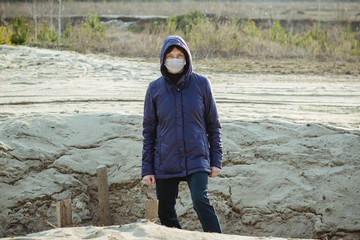 A woman in a disposable medical mask in a trench. Covid 19. Pandemic. Ukraine. Europe. Quarantine.