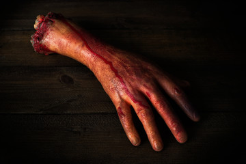 severed hand in the blood - Powered by Adobe