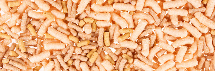 Fish food in sticks for aquarium and pond fish. Fish feed background