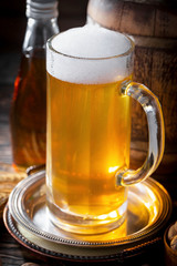Light beer in a glass on a table in composition with accessories on an old background