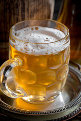 Light beer in a glass on a table in composition with accessories on an old background