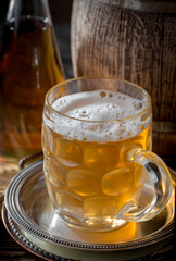 Light beer in a glass, on an old background.