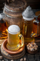 Light frothing beer in a glass, on an old background.