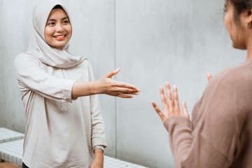social distancing. woman refuse to touch while meeting with friend