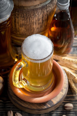 Light beer in a glass on a table in composition with accessories on an old background
