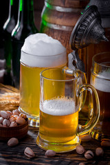 Light beer in a glass on a table in composition with accessories on an old background
