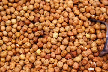 peeled hazelnuts in a tray with a spatula in a supermarket